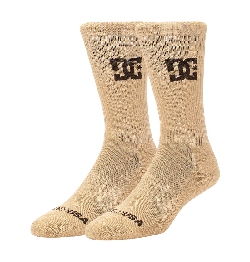 A 6-pack of beige crew socks by DC Shoes, each featuring a black logo on the side and “DC USA” text on the toe, displayed upright against a white background.