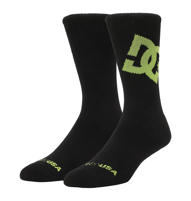 The Graffik Logo Crew Socks 3-Pack by DC Shoes includes black crew socks with a bold neon green DC Shoes logo on the side and USA in green near the toes.