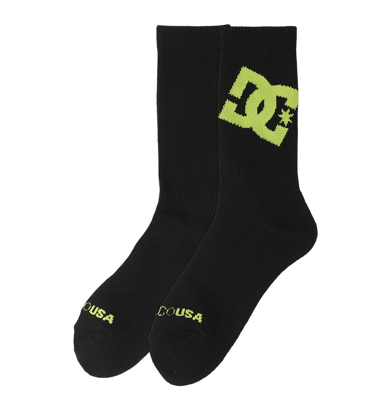 A pair of black Graffik Logo Crew Socks by DC Shoes featuring a large yellow DC Shoes logo on the side and "DC USA" in yellow on the toes.