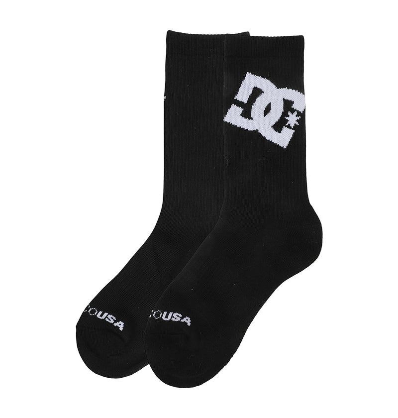 A pair of black Graffik Logo Crew Socks by DC Shoes featuring a large white DC Shoes logo near the top and small white DC USA text by the toes, shown on a plain white background.