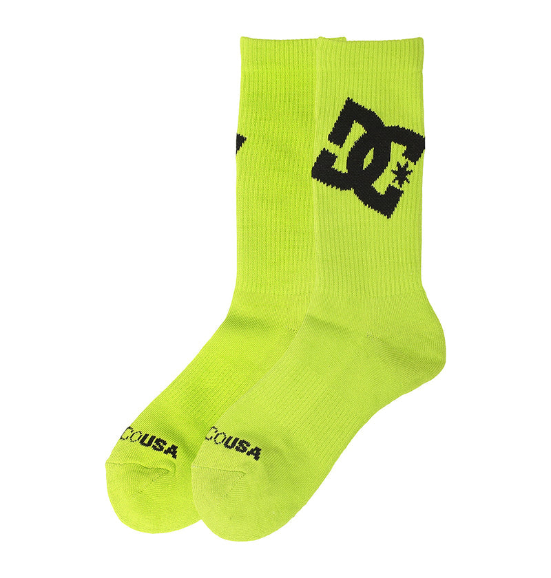 A pair from the DC Shoes Graffik Logo Crew Socks 3-Pack in bright yellow-green features black DC branding on the sides and “DCSHOECOUSA” printed on the toes.