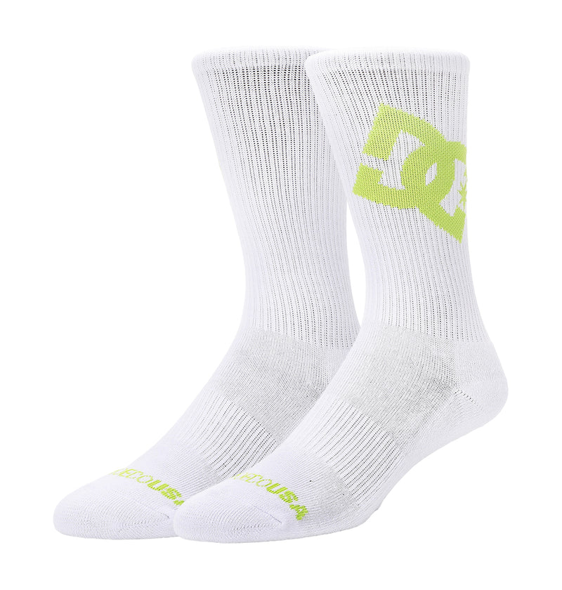 The Graffik Logo Crew Socks 3-Pack by DC Shoes features white ribbed crew socks with a large light green DC Shoes logo on the side and "DC SHOES" text in light green on the toes.