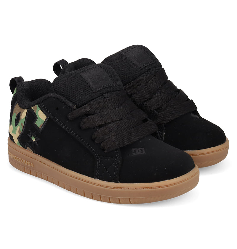The DC Shoes Kids' Court Graffik Shoes are black, skate-style sneakers with a puffy silhouette, thick laces, tan rubber soles, camo heel accents, subtle branding, and a distinctive Court Graffik-inspired low-top design.