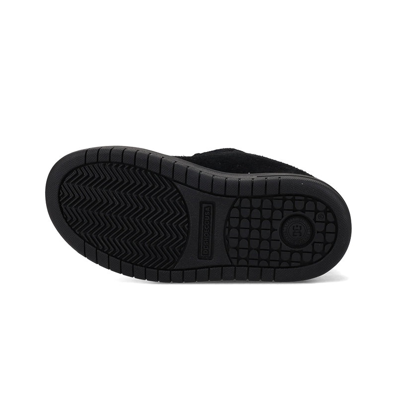The image shows the black rubber sole of the Kids' Court Graffik Special Edition Shoes by DC Shoes, featuring a textured grip with zigzag lines and small square treads, photographed against a white background.