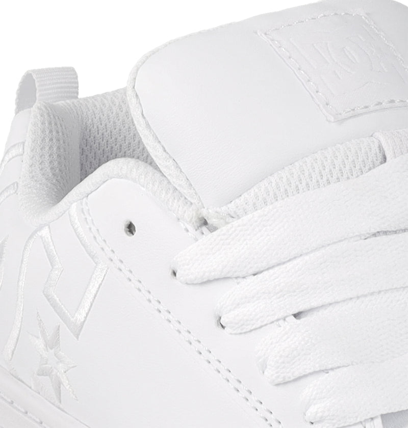 Close-up of the Kids' Court Graffik Shoes by DC Shoes, featuring a white design with textured tongue, white laces, stitched star and geometric logos, plus perforated eyelets—a classic skate-inspired style for kids.