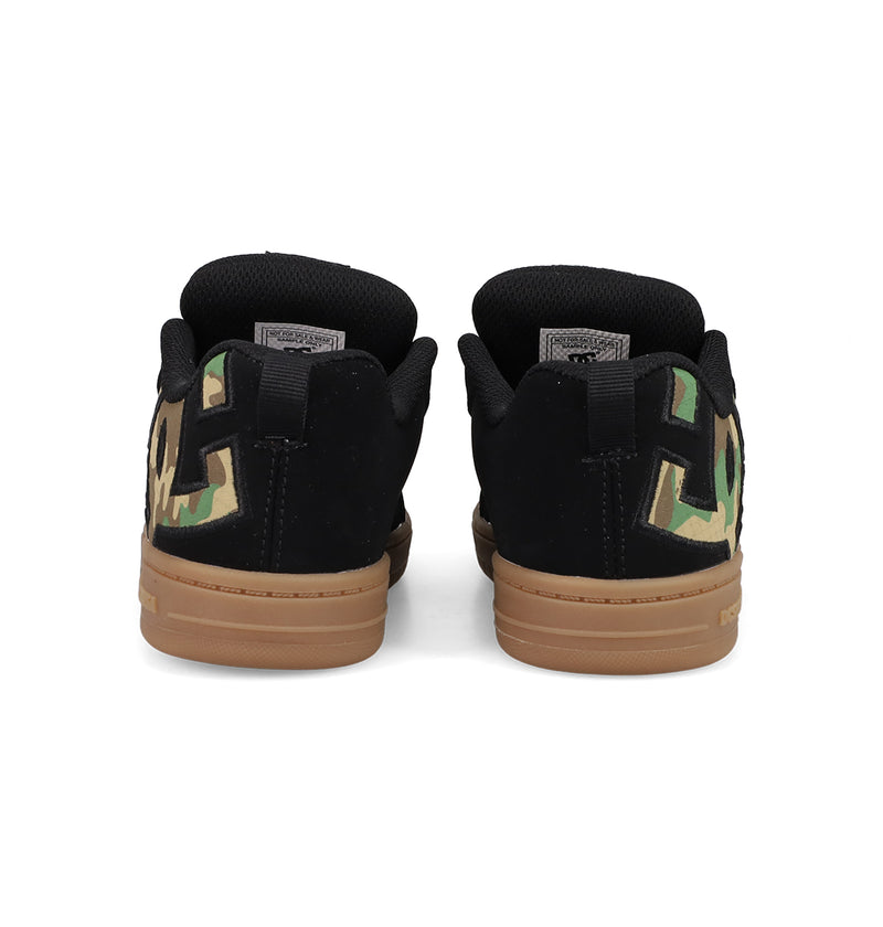 A pair of black Kids' Court Graffik Shoes by DC Shoes with brown soles, large DC logo branding in green camo on the heels, and a puffy low-top silhouette, shown from the back.