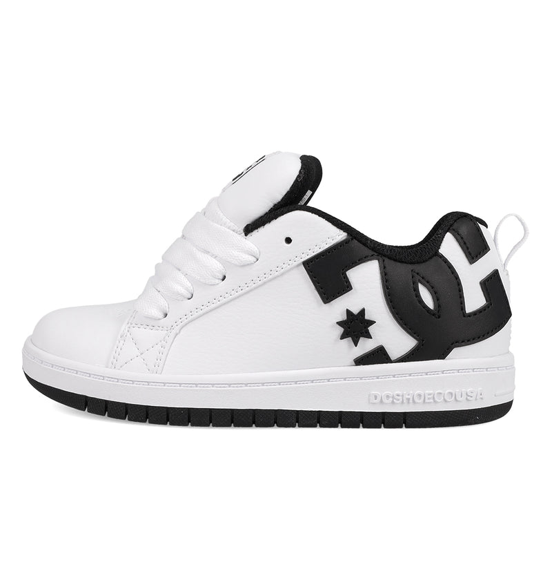 The DC Shoes Kids' Court Graffik Shoes feature a white low-top design with a thick sole, black heel and collar, bold black DC logo on the side, skate-inspired style, white laces, and subtle stitching details.