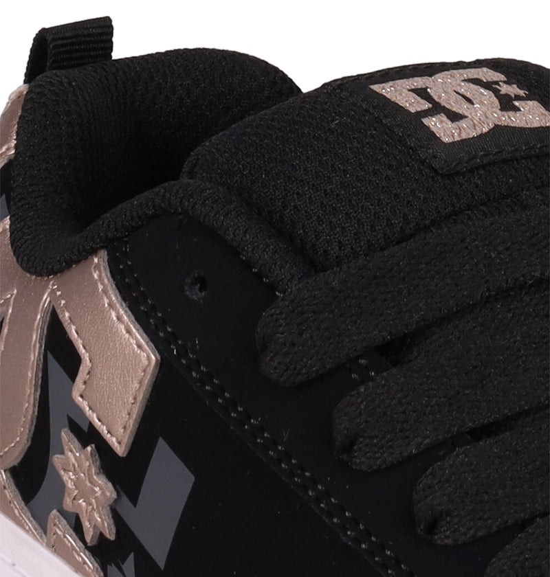Close-up of the Kids' Court Graffik Shoes by DC Shoes, featuring a classic puffy silhouette, thick black laces, metallic gold DC logo details, padded tongue, detailed stitching, and a fabric pull tab at the heel.