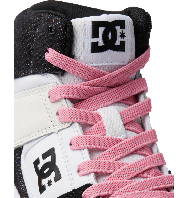 Close-up of black and white DC Shoes Kids' Cure High-Top sneaker with pink laces. Features visible DC logo on tongue and side, plus an abrasion-resistant rubber outsole for lasting durability.