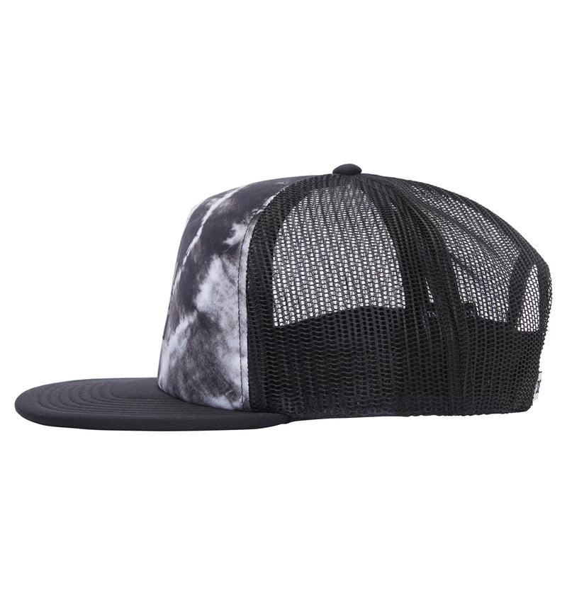 The Reebok Gas Station Trucker Boy is a black mesh trucker hat with a flat brim and a white and black tie-dye front panel, shown in profile.