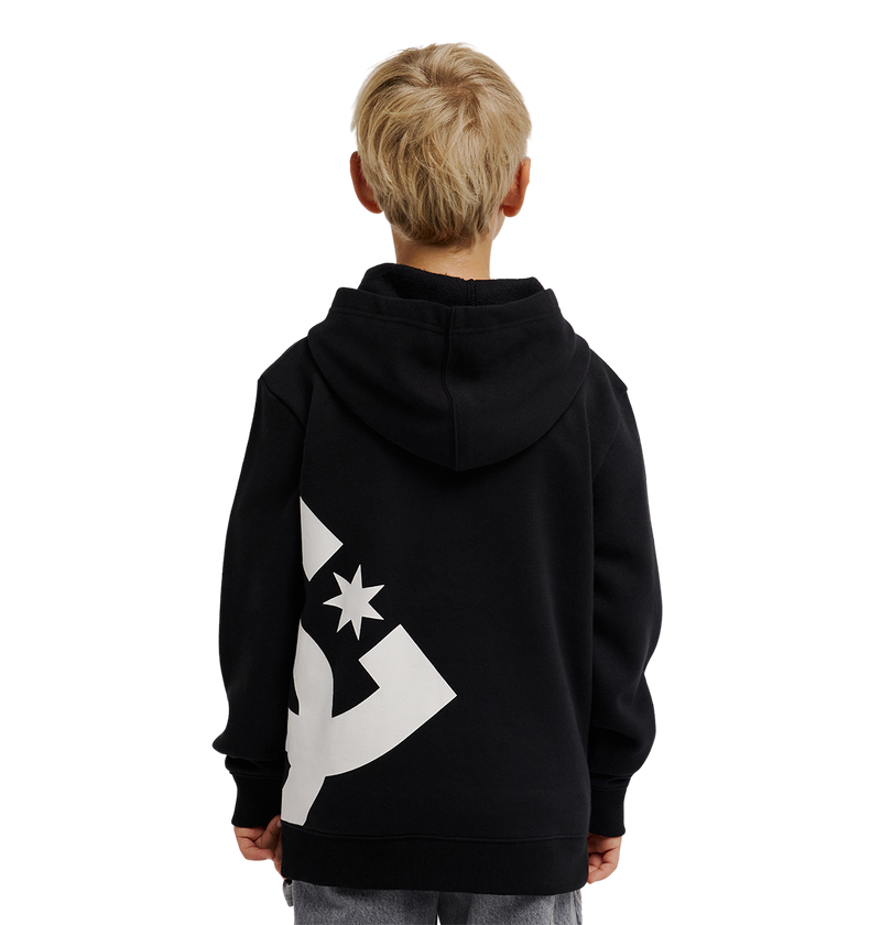 A young boy with blond hair, seen from behind, wears the DC Shoes Lanai Hoodie Youth in black with bold graphics on the back, standing against a plain white background.
