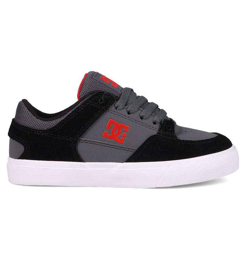 The Kids' Onyx Shoes by DC Shoes feature a black and gray vulc style with a white sole, red side logo, gray laces, and mesh ankle details—perfect low-tops for kids seeking everyday comfort and standout style.