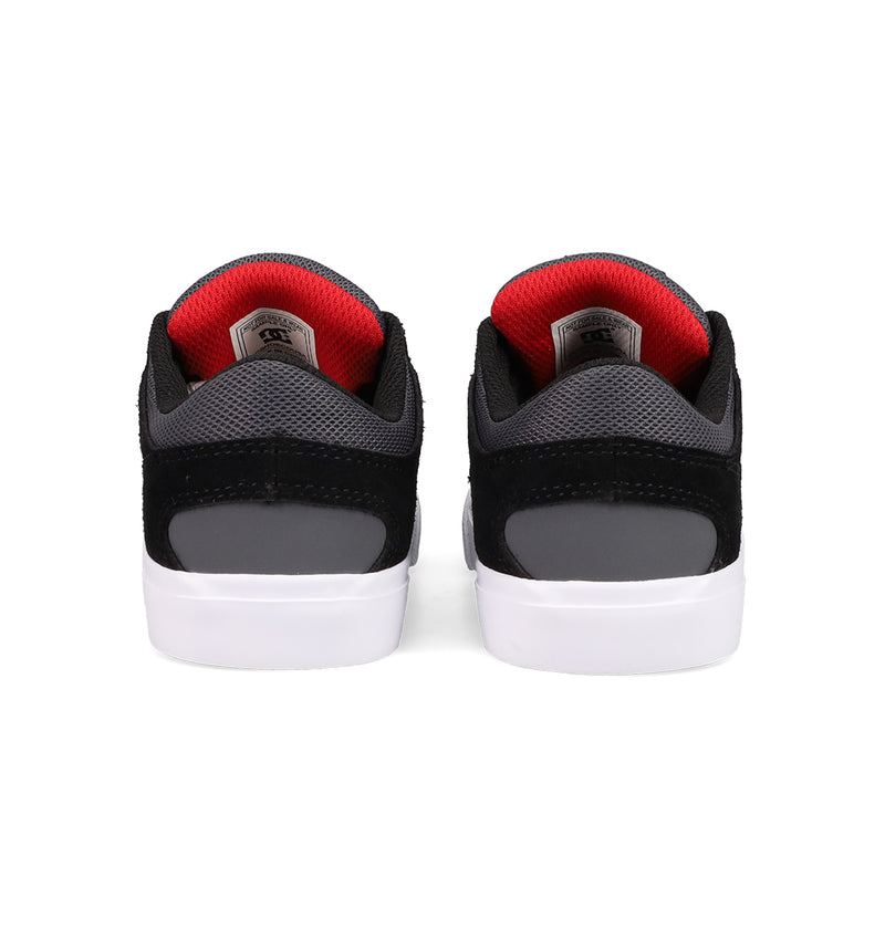 DC Shoes Kids' Onyx Shoes in gray and black, featuring red inner lining and white soles, are shown from the back against a white background—perfect for everyday wear.