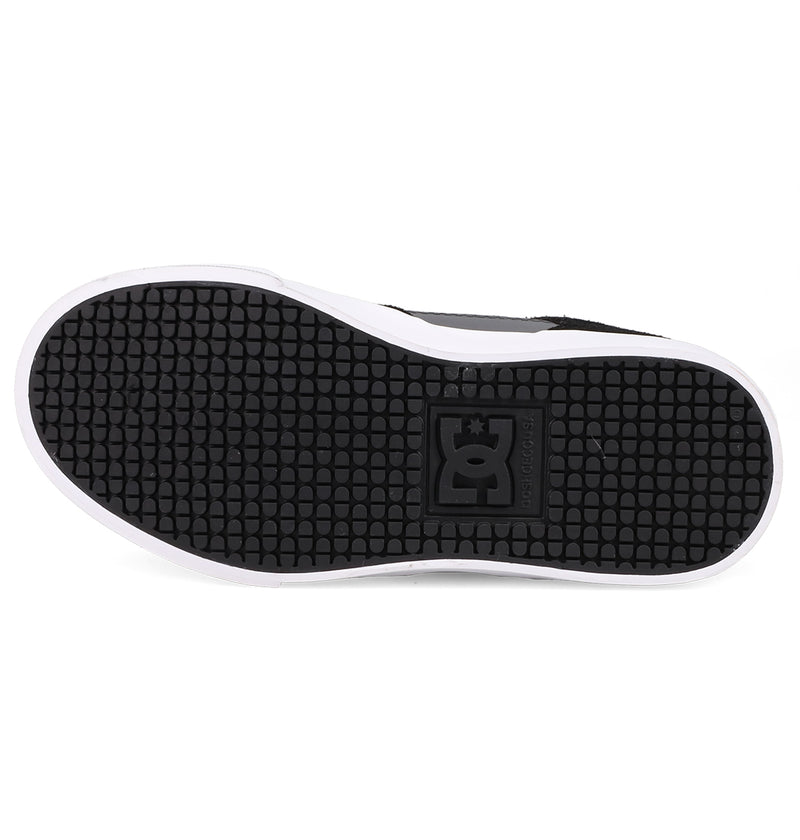 The image shows the onyx black rubber sole of Kids' Onyx Shoes by DC Shoes, featuring a textured grid pattern with a square DC logo at the center and a white edge around this everyday go-to sneaker.