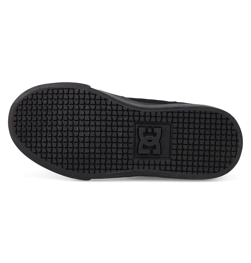 The image displays the black rubber sole of the Kids' Onyx Shoes by DC Shoes, featuring a hexagonal tread pattern and an embossed DC logo at the center, emphasizing its streamlined silhouette.