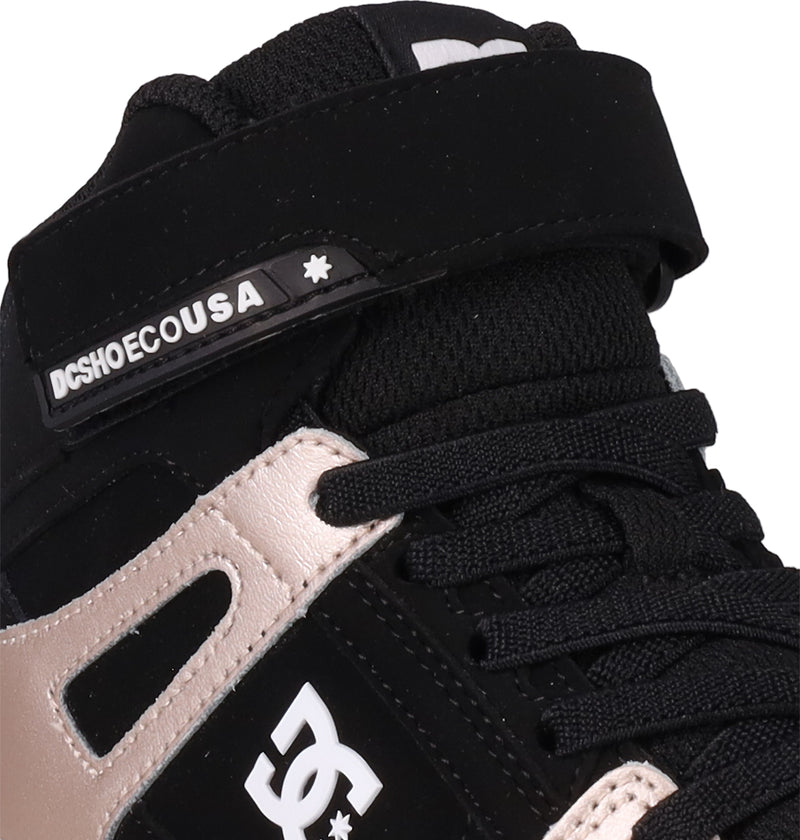 Close-up of DC Shoes Kids' Pure Hi Top EV, a black and beige high-top sneaker featuring laces, Velcro strap, vulcanized outsole, and DCSHOECOUSA branding with the signature DC logo on the side.