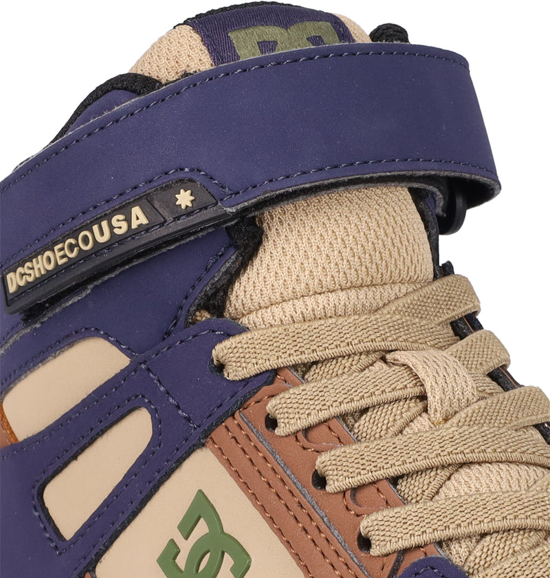 Close-up of DC Shoes Kids' Pure Hi Top EV Shoes featuring tan, brown, and purple panels, beige laces, a Velcro strap with DCSHOECOUSA and star branding, plus the iconic logo on the side—perfect for kids’ skate style.