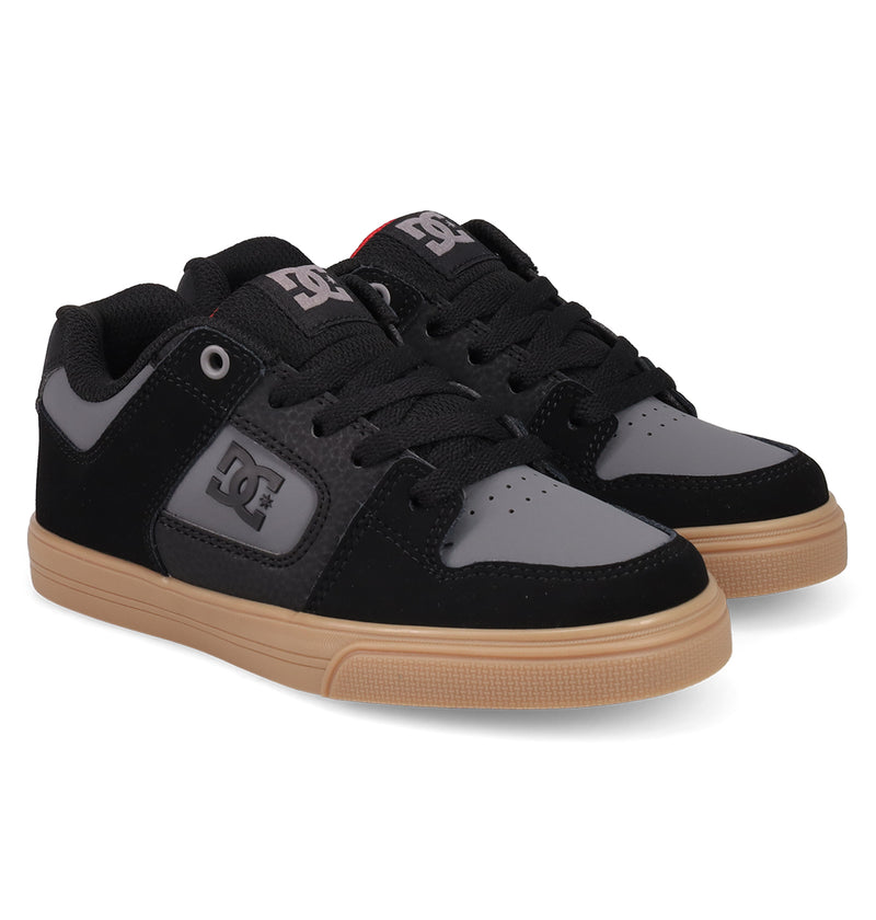 A pair of DC Shoes Kids' Pure Shoes, featuring black and gray uppers, black laces, and light brown rubber soles, displayed side by side on a white background for a versatile look.