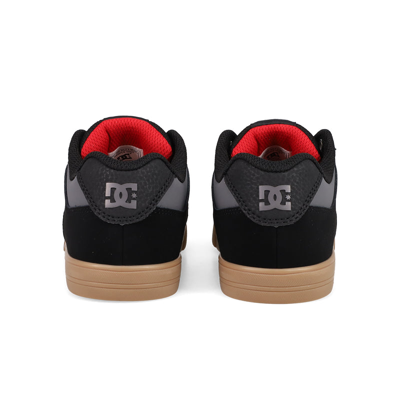 Back view of Kids' Pure Shoes by DC Shoes—black and gray with brown soles, red inner lining, and DC logo on the heel—comfortable for skating and everyday wear.