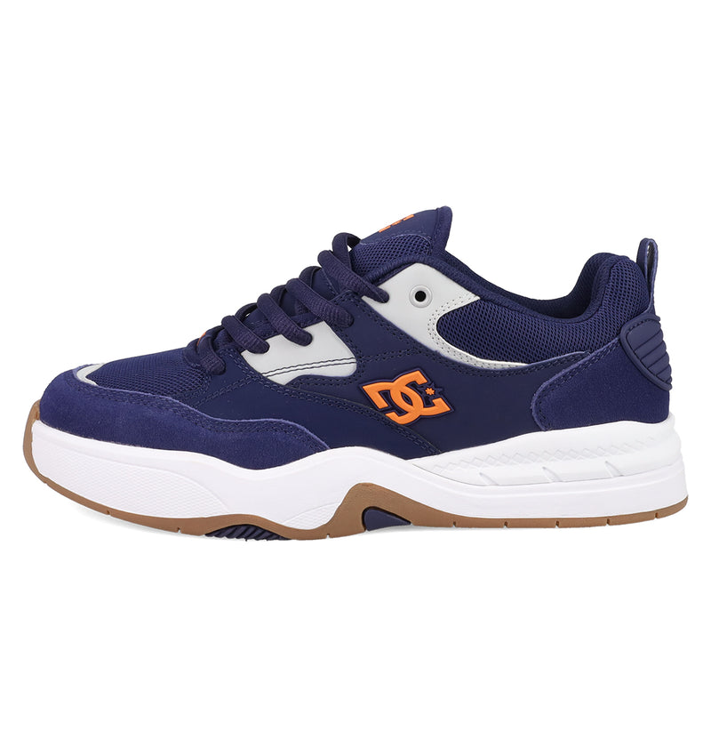 The Men's DC Ascend S Shoes by DC Shoes feature a navy blue design with white and gray accents, orange DC DNA-inspired side logo, white sole with brown bottom, black laces, and modern comfort—reflecting Josh Kalis's iconic style.