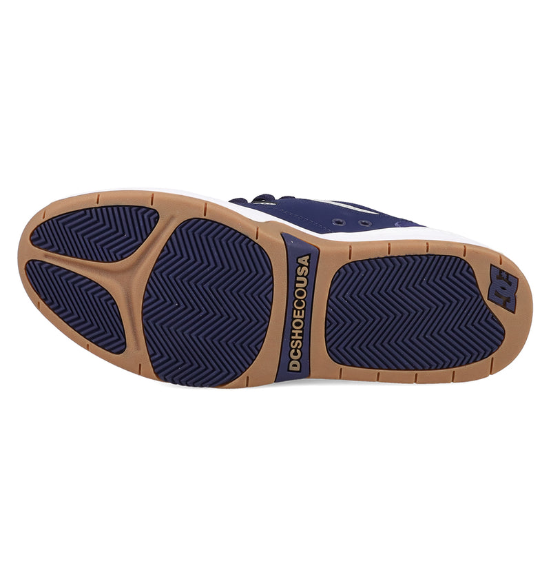 The image shows the sole of the Men's DC Ascend S Shoes by DC Shoes. The tan sole has navy blue rubber grips, a herringbone tread, and "DCSHOECOUSA" plus the DC Shoes logo in navy near the arch and heel.