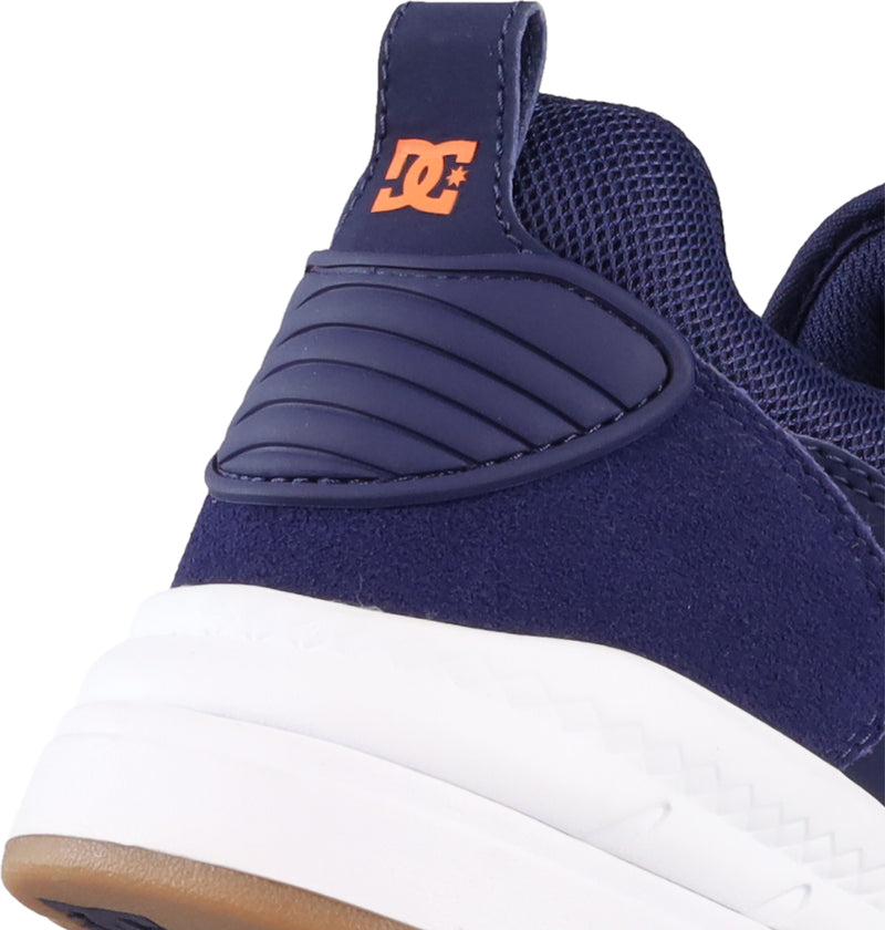 Close-up of the Men's DC Ascend S Shoes by DC Shoes, showcasing the dark blue mesh and suede upper, white sole, and a small orange DC logo on the heel tab for a modern look that honors classic DC design.