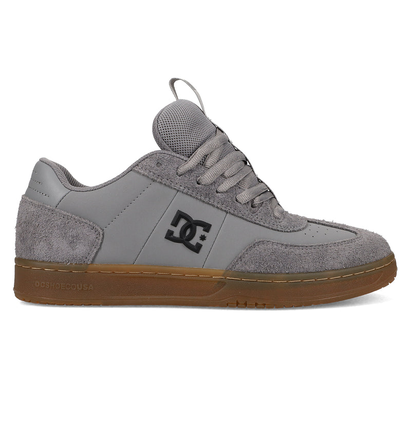 The Men's Astrix Shoes by DC Shoes feature a grey suede and mesh upper, gum rubber sole for board control, black DC logo on the side, grey laces, and a tongue pull tab—ideal for street skateboarding.