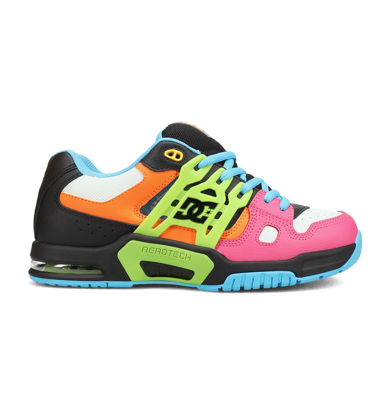 The DC Shoes Men's AT-2 features a chunky, modern athletic design with black, white, orange, pink, and green panels; blue laces and sole; a supportive TPU cage for stability; and the DC Shoes logo on the side.