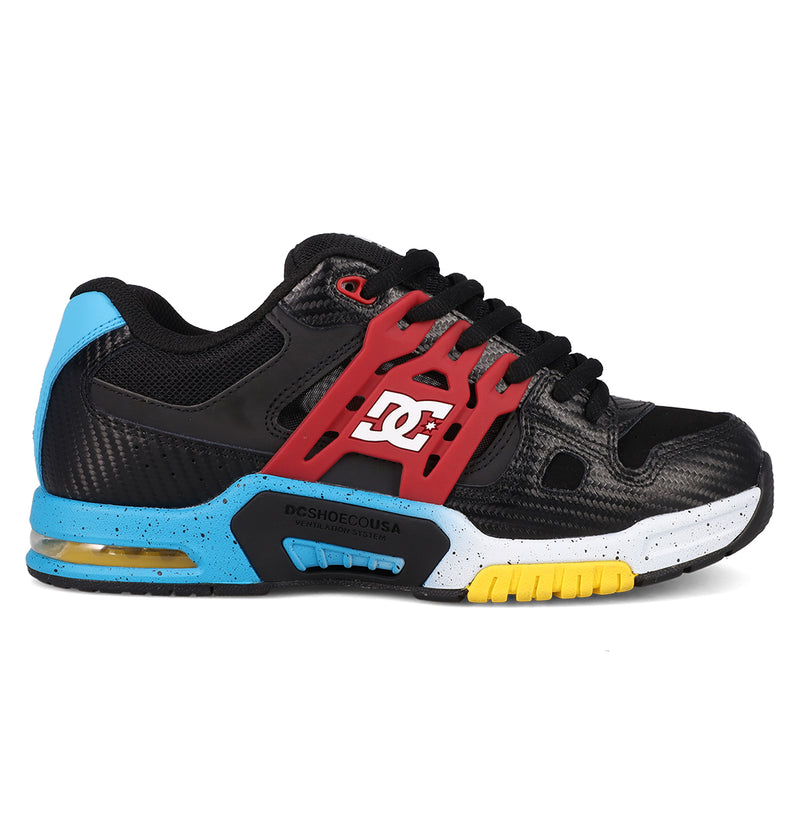 The Men's AT-2 Shoes by DC Shoes feature a black design with red side accents, blue heel and sole details, yellow tread on the front sole, a white speckled midsole, a white DC logo, and AEROTECH ventilation for breathable comfort.