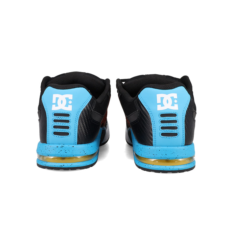 The DC Shoes Men's AT-2 features black uppers, blue heels with a white DC logo, yellow and blue sole details, and offers breathable comfort for all-day wear.