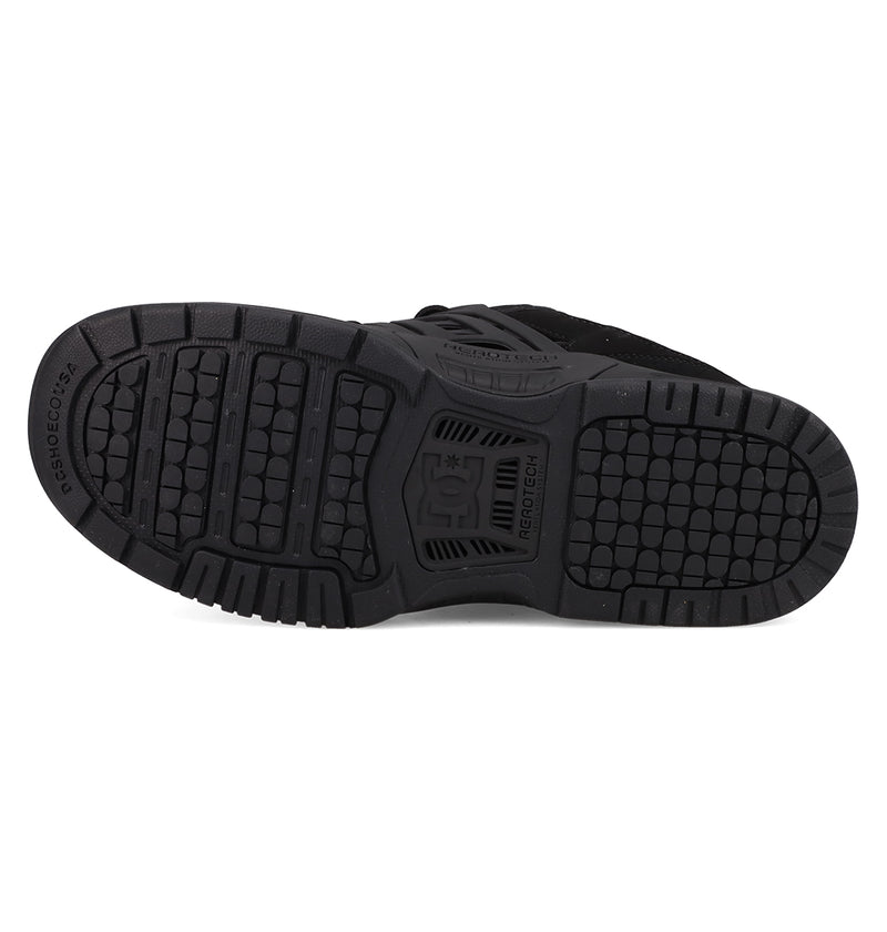 The image shows the black rubber sole of the Men's AT-2 Shoes by DC Shoes, featuring a textured tread pattern with the DC logo in the center and AEROTECH ventilation for breathability.