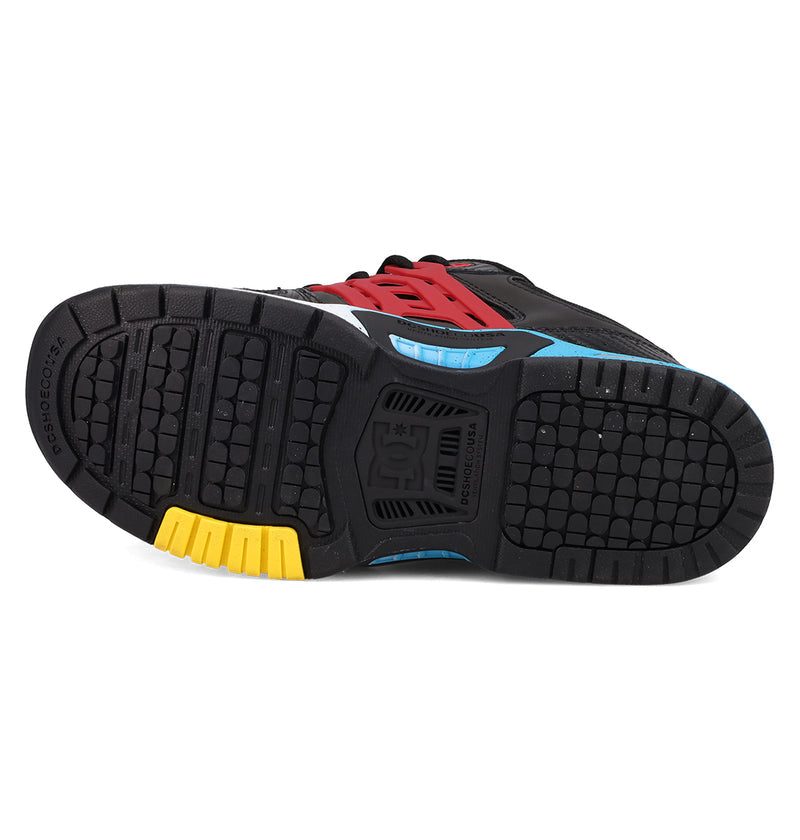 Bottom view of the DC Shoes Men's AT-2 shows a black textured rubber sole with yellow, blue, and red accents, featuring the DC logo embossed in the center and AEROTECH ventilation for breathable comfort.