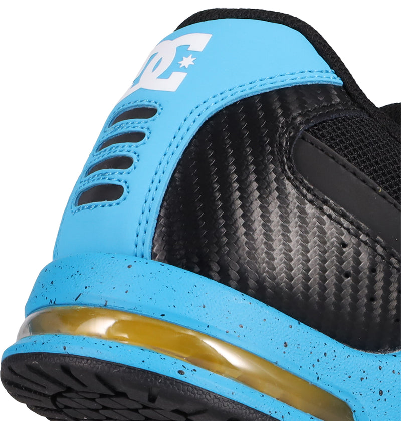 Close-up of the heel of the DC Shoes Men's AT-2, showing a blue heel section with black dotted texture, visible air-cushioned outsole, and part of the white DC logo on the blue heel tab.