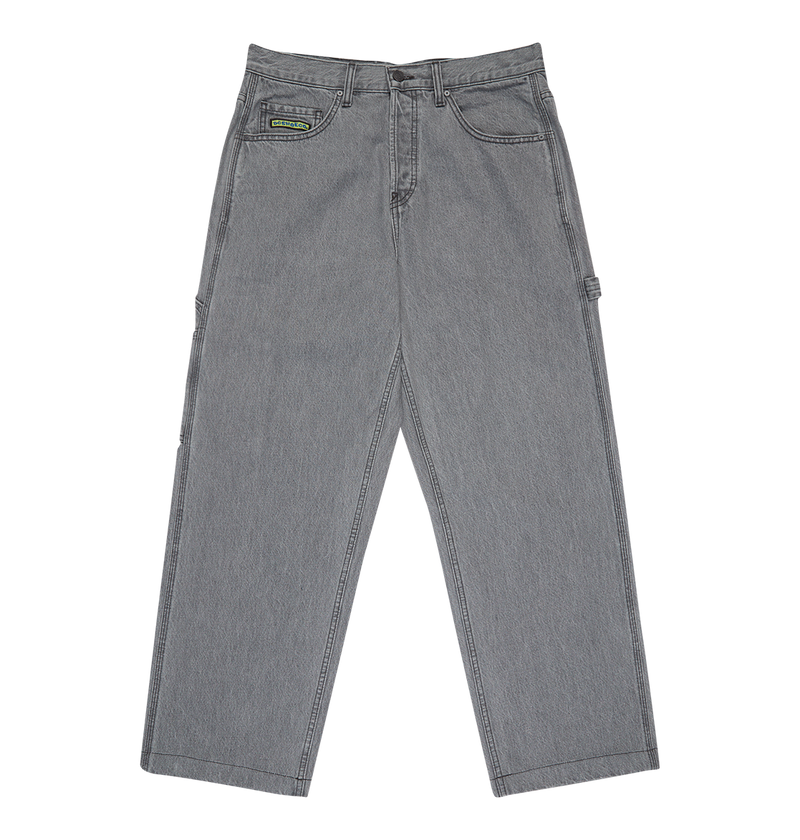 The DC Shoes Men's Baggy Denim Carpenter Pant in gray features a relaxed, wide-leg fit, five pockets, belt loops, and a small green and black label on the right front pocket, shown flat on a white background.
