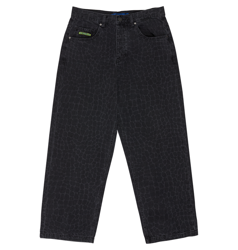 The DC Shoes Men's Baggy Denim Snake Print Pant features a subtle laser reptile-skin pattern, five pockets, a green label on one front pocket, and a baggy fit. Shown laid flat on a white background.