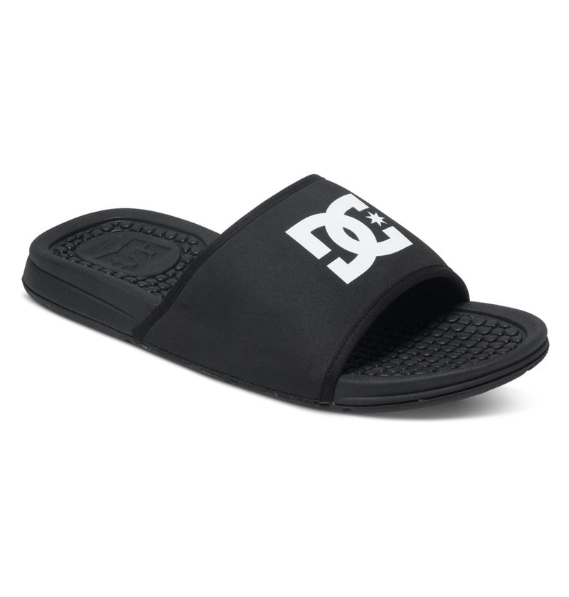 The Men's Bolsa Slides by DC Shoes feature a black design with a textured footbed and a wide strap displaying the white DC Shoes logo—ideal for relaxing after skate sessions.