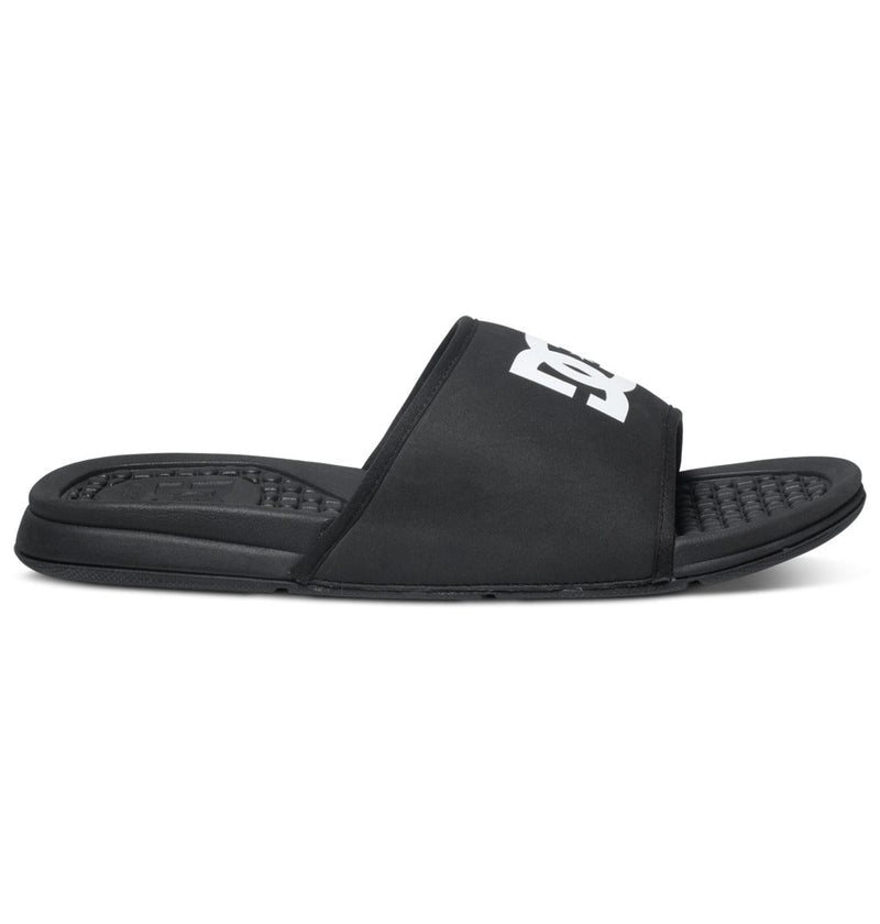 The Men's Bolsa Slides by DC Shoes feature a black textured footbed and wide strap with a bold white logo, offering casual style and all-day comfort—ideal for post-skate relaxation or everyday wear.