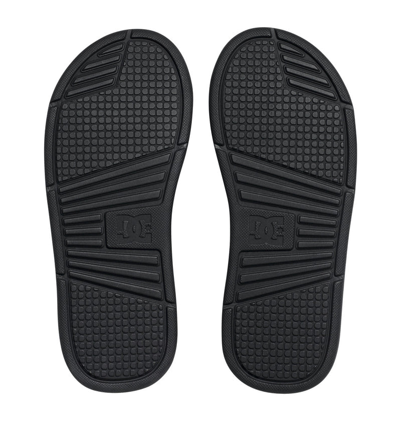The men's Bolsa Slides by DC Shoes feature black rubber soles with textured grip patterns and an embossed DC Shoes logo at the center—ideal for traction whether lounging or on the move.