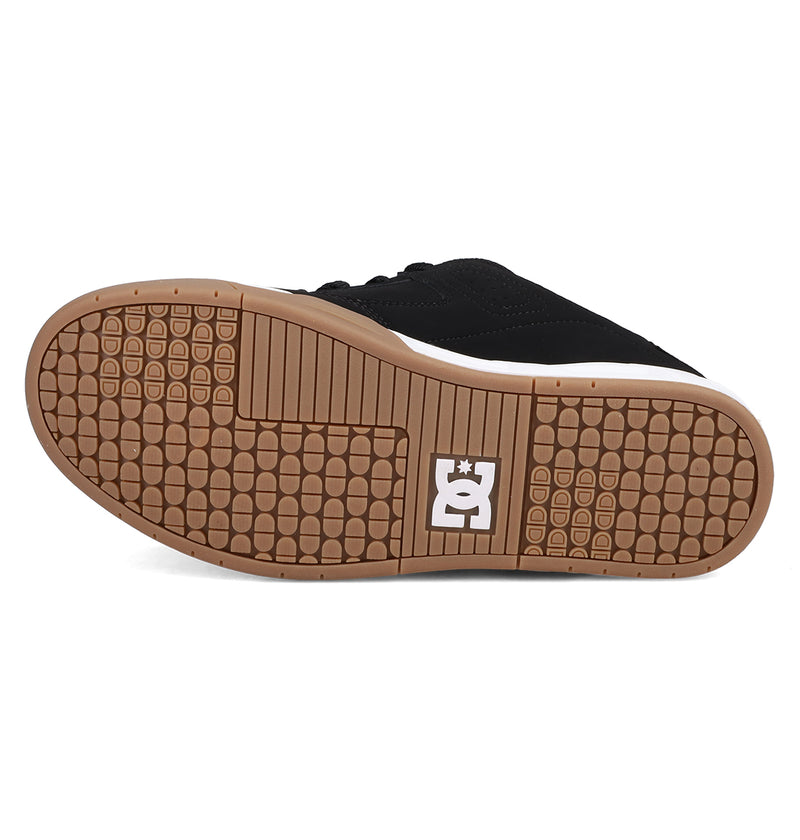 The image shows the sole of the Men's DC Command Shoes by DC Shoes, featuring a black upper, brown textured rubber bottom with a square grid tread pattern, and a white DC Shoes logo near the heel, reflecting its skate-inspired style.