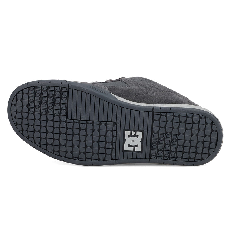 The image displays the black rubber sole of the Men's DC Command Shoes by DC Shoes, featuring a grid tread pattern and a white DC logo at the center, highlighting its skate-inspired, street-ready style.