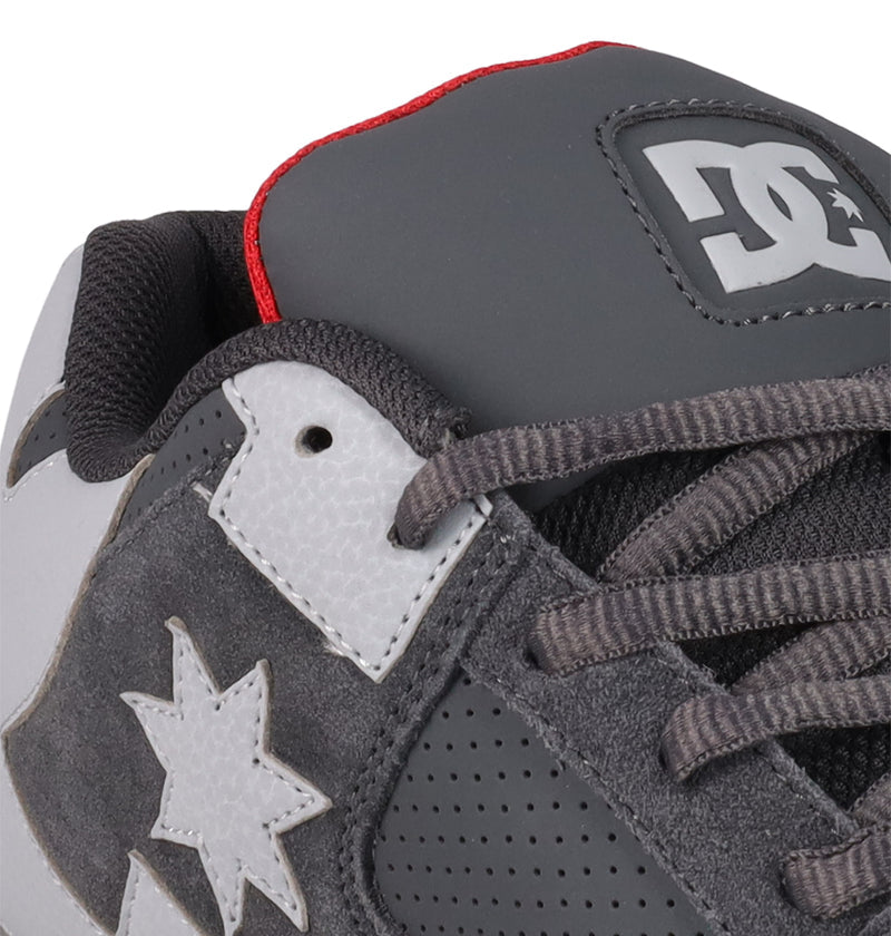 Close-up of Men's DC Command Shoes highlights their street-ready design, black tongue with white DC Shoes logo, gray laces, red trim, and a star detail on the suede side panel.