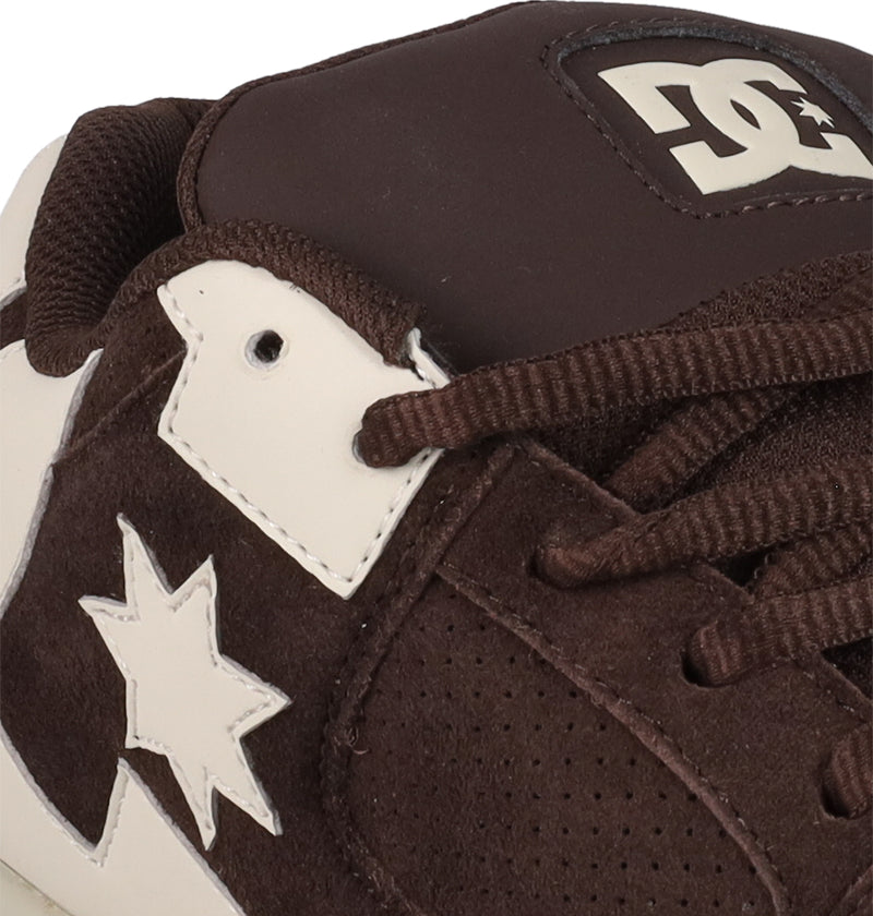 Close-up of a brown and white Men's DC Command SE Shoe by DC Shoes, showing laces, partial logo on the tongue, star detail on the side, and featuring suede and leather materials with signature cushioning for modern comfort.