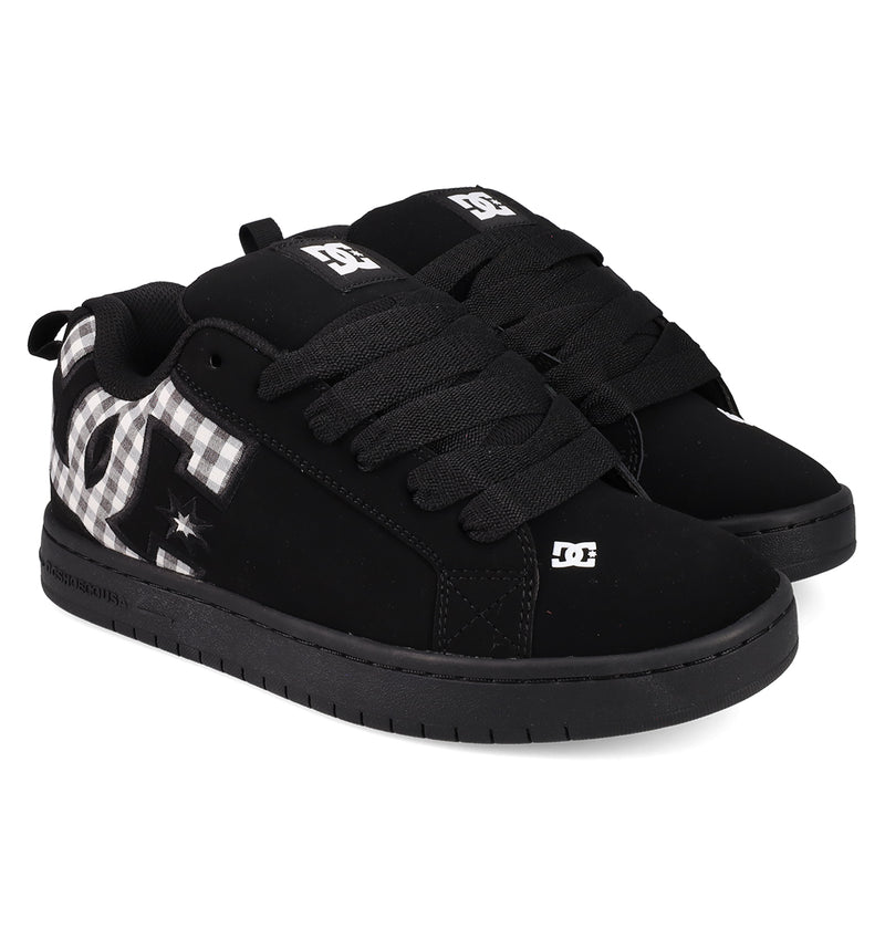 A pair of Men's Court Graffik Shoes by DC Shoes featuring thick black laces, a black-and-white patterned DC logo on the side, white DC logos on the tongue and toe, classic puffy silhouette, and black soles.