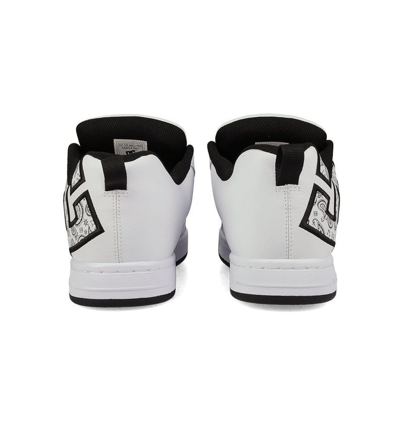 Rear view of DC Shoes Men's Court Graffik Shoes: white low-tops with black interiors, DC logo pull tabs, and black-and-white geometric side designs near the heels that capture the signature style.