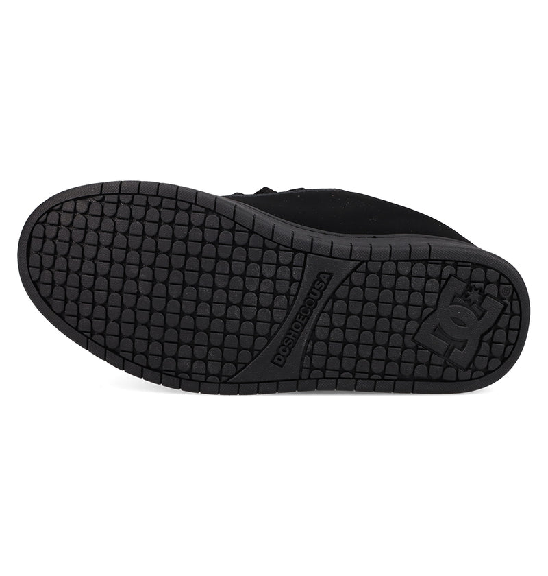 The image displays the black rubber sole of the DC Shoes Men's Court Graffik, featuring a grid-like tread and embossed DC logo near the heel, along with "DURABILITÉ.