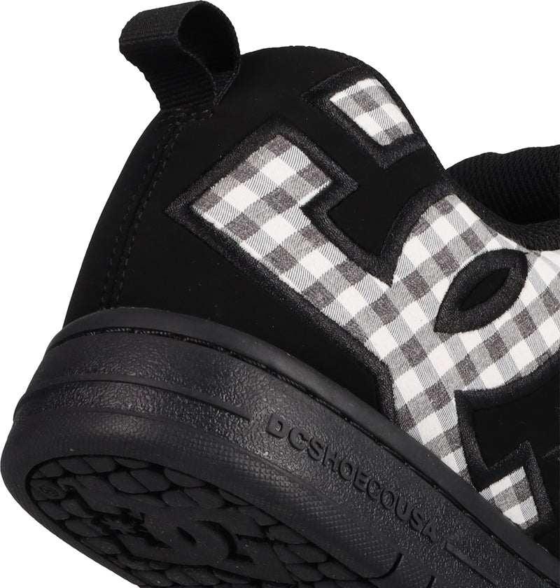 Close-up of the heel and side of men's Court Graffik shoes by DC Shoes, showing the puffy silhouette, bold DC logo lettering, DCSHOECOUSA embossed on the sole, and a black-and-white checkered pattern for a signature look.