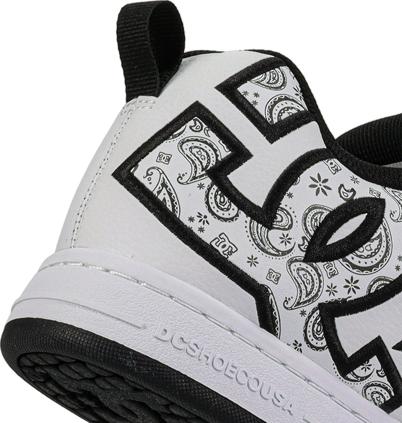 Close-up of the heel and side of DC Shoes Men's Court Graffik Shoes in white, with a large black outline DC logo filled with paisley pattern, puffy silhouette, black pull tab, and DCSHOECOUSA embossed on the white midsole.