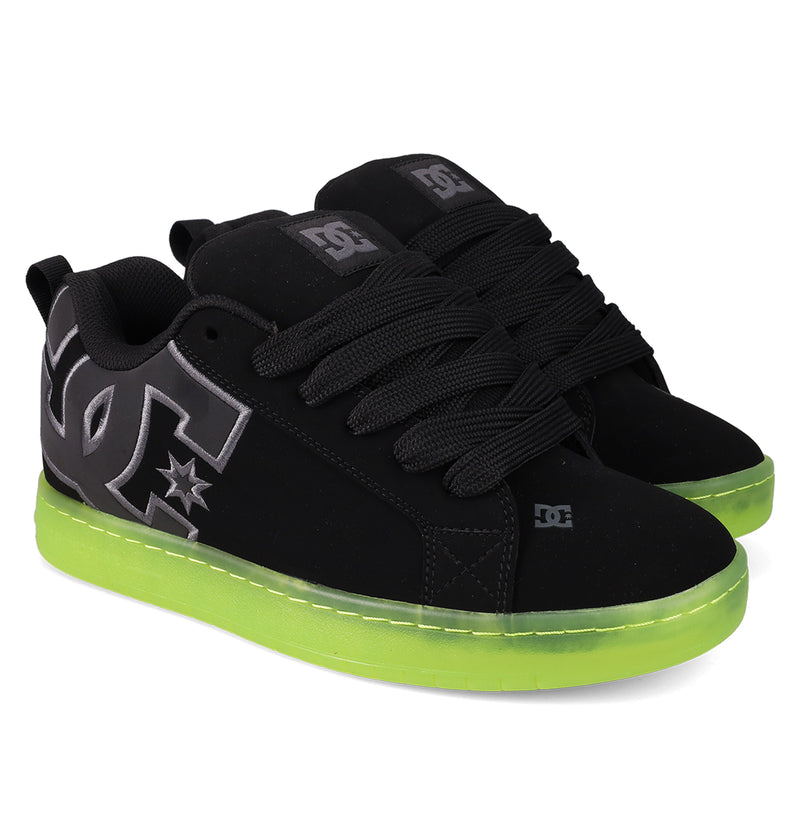 The DC Shoes Men's Court Graffik SE features a puffy black silhouette, thick black laces, bold silver DC logos on the sides, and neon green soles.