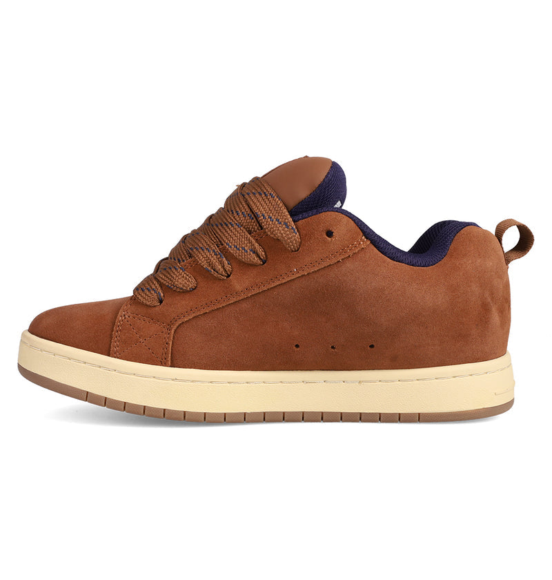 The DC Shoes Men's Court Graffik SE features a brown suede upper, puffy silhouette, beige sole, brown laces, and dark blue inner lining. Shown in a left side profile on a white background.