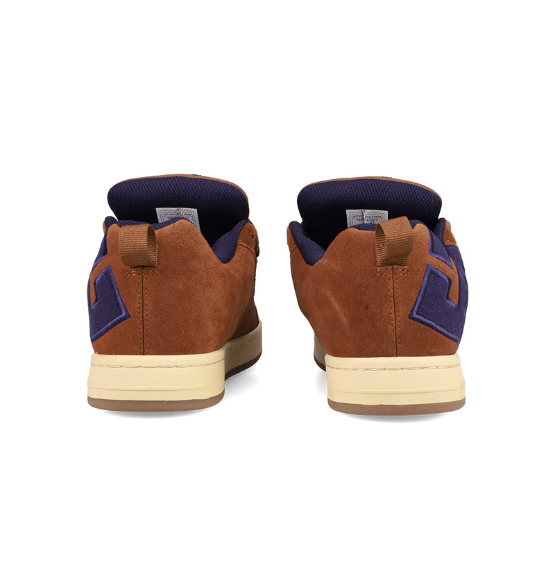 Back view of DC Shoes Men's Court Graffik SE Shoes in brown suede with beige soles, dark blue accents, geometric heel designs, pull tabs, puffy silhouette, and dark blue inner lining.